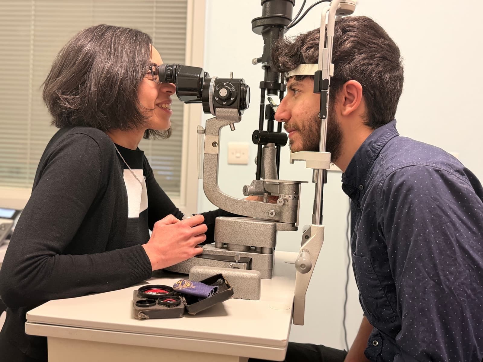 Ms. Menassa with a patient during an eye care consultation